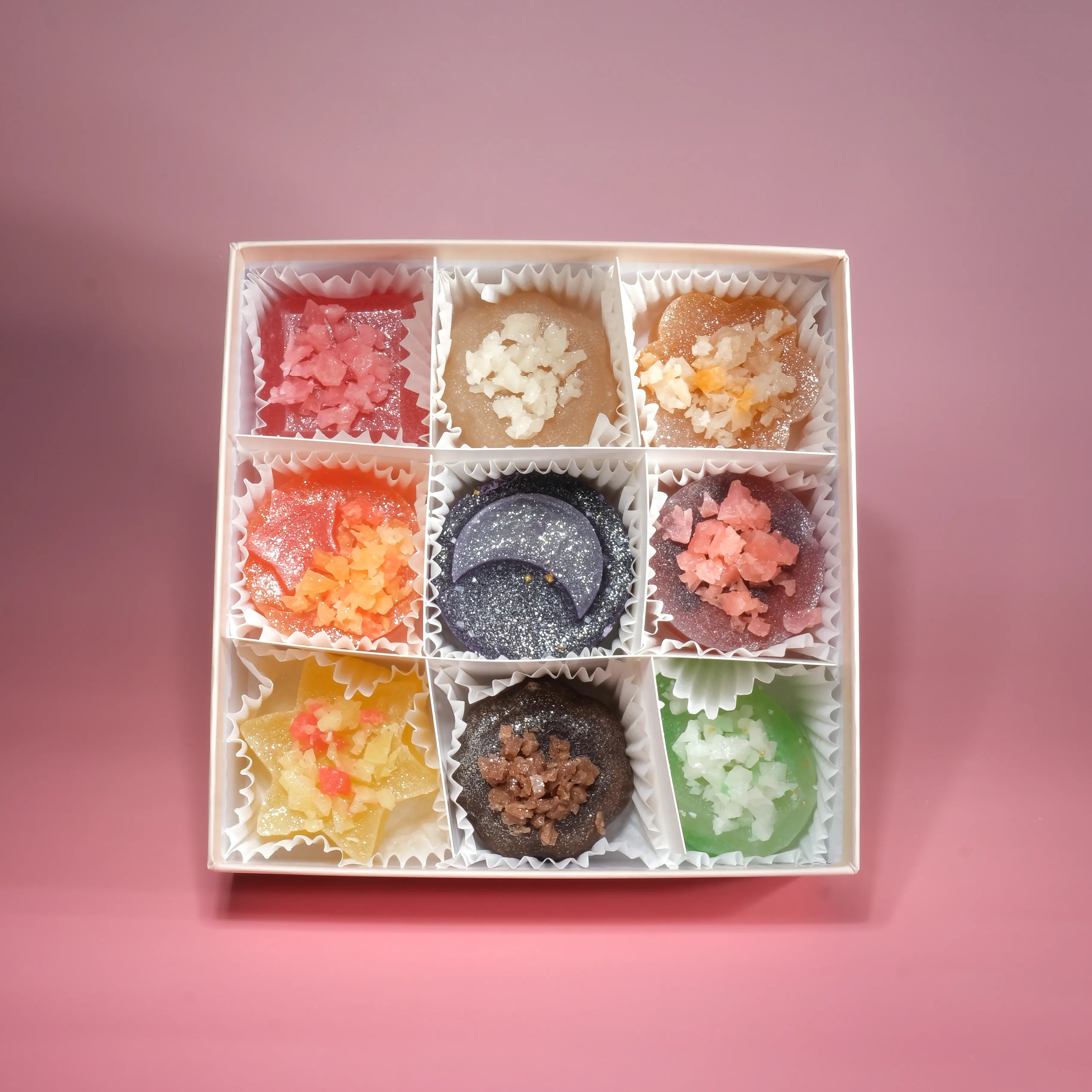 Assorted Silky Gem crystal candy collection featuring multiple flavors arranged in a gift box, each with a crunchy shell and firm jelly center.