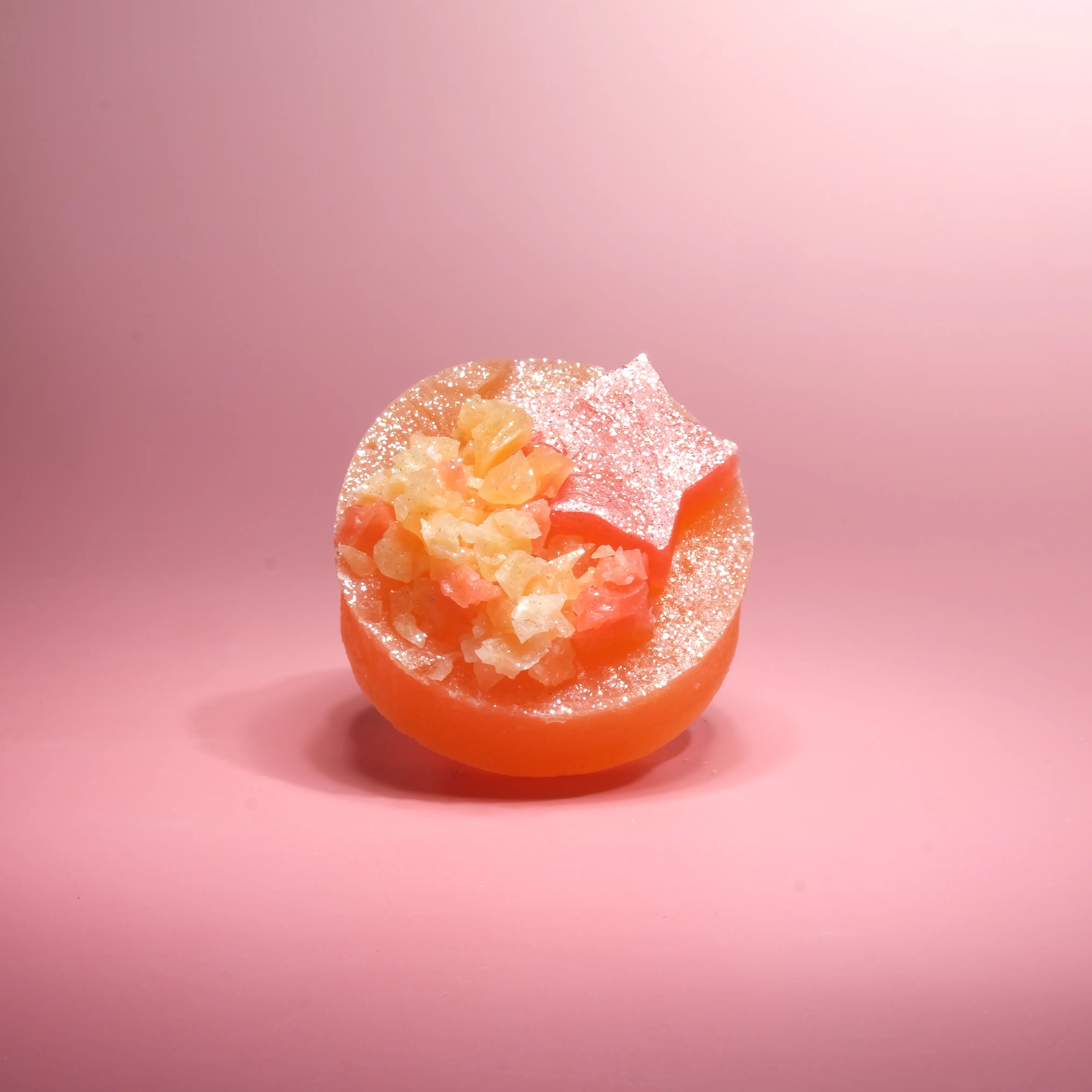 Blood orange passion fruit crystal candy with a bold orange-red shell and crystalline topping, showcasing Silky Gem’s handcrafted detail.