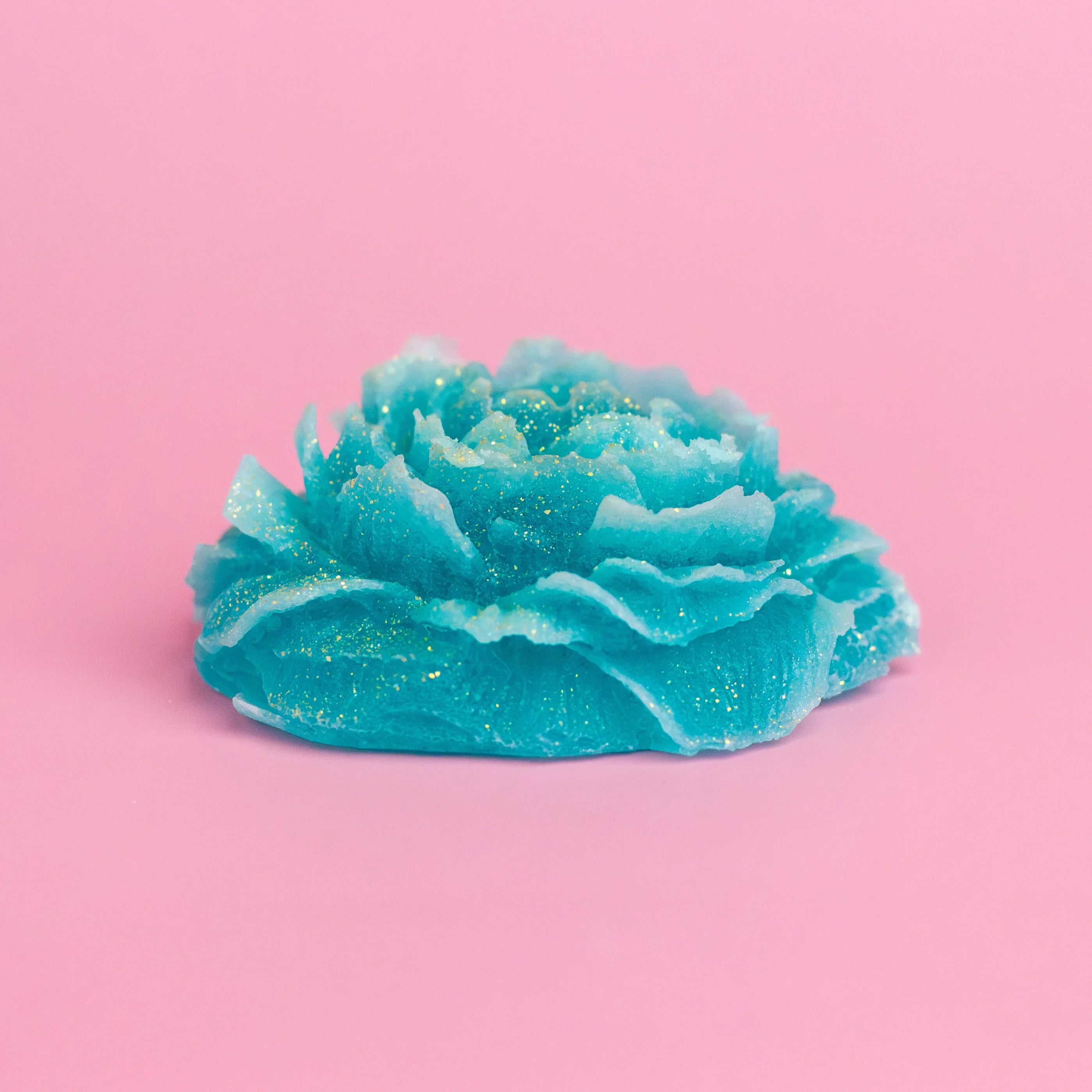 Blue foamy soap bar on a pink background