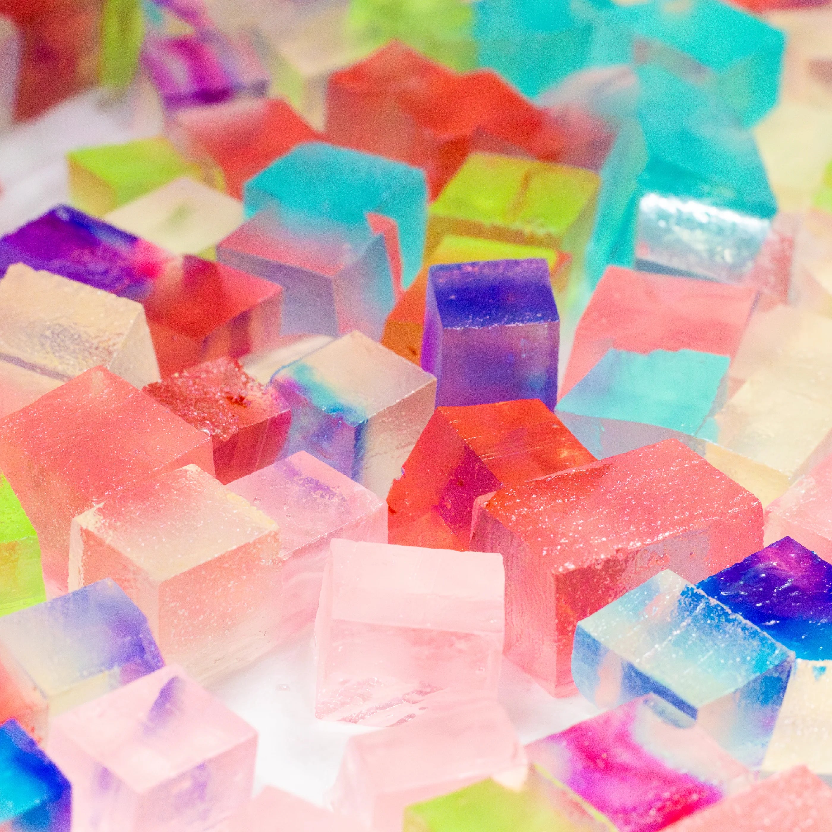 Colorful transparent jelly cubes on a white background