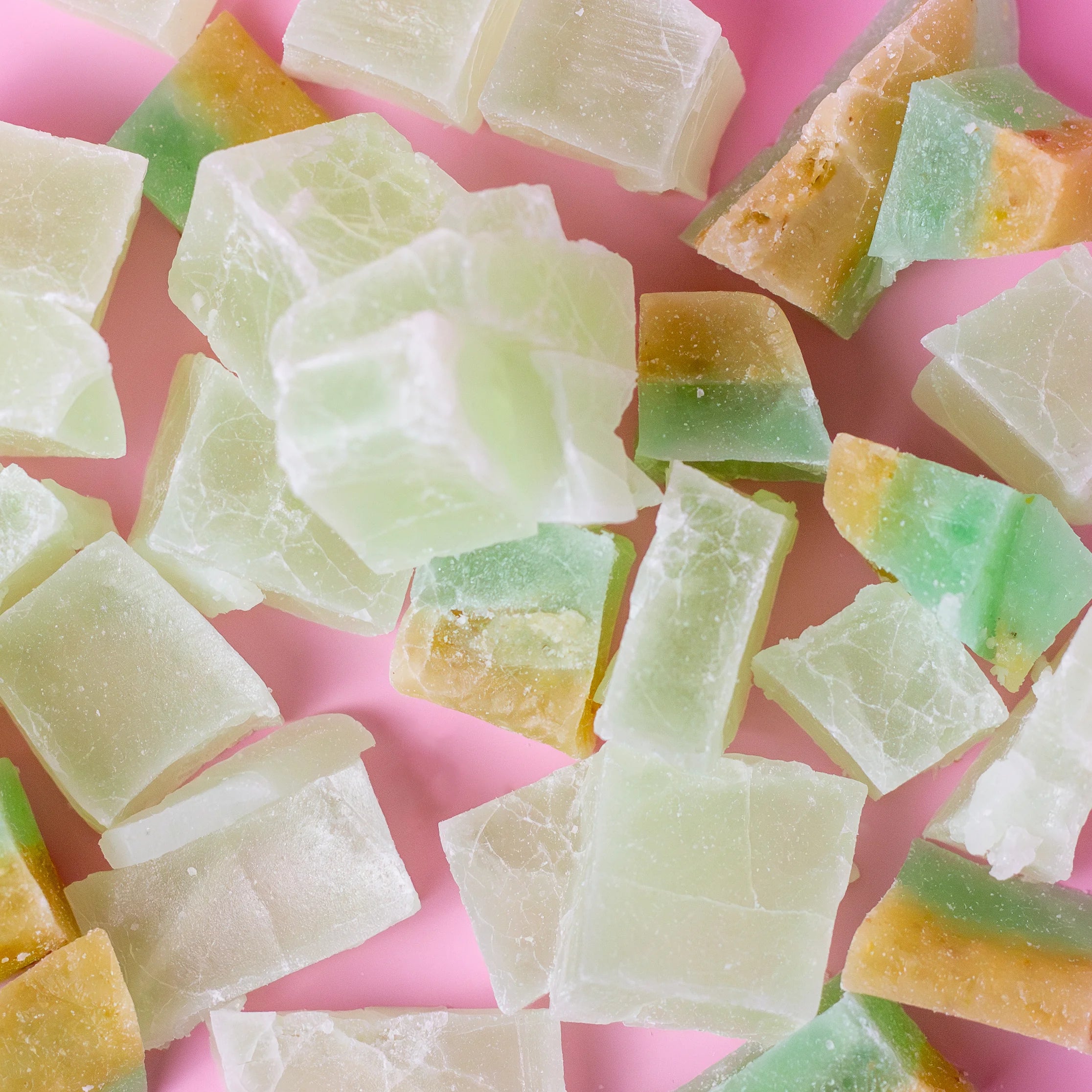 Colorful jelly cubes on a pink background