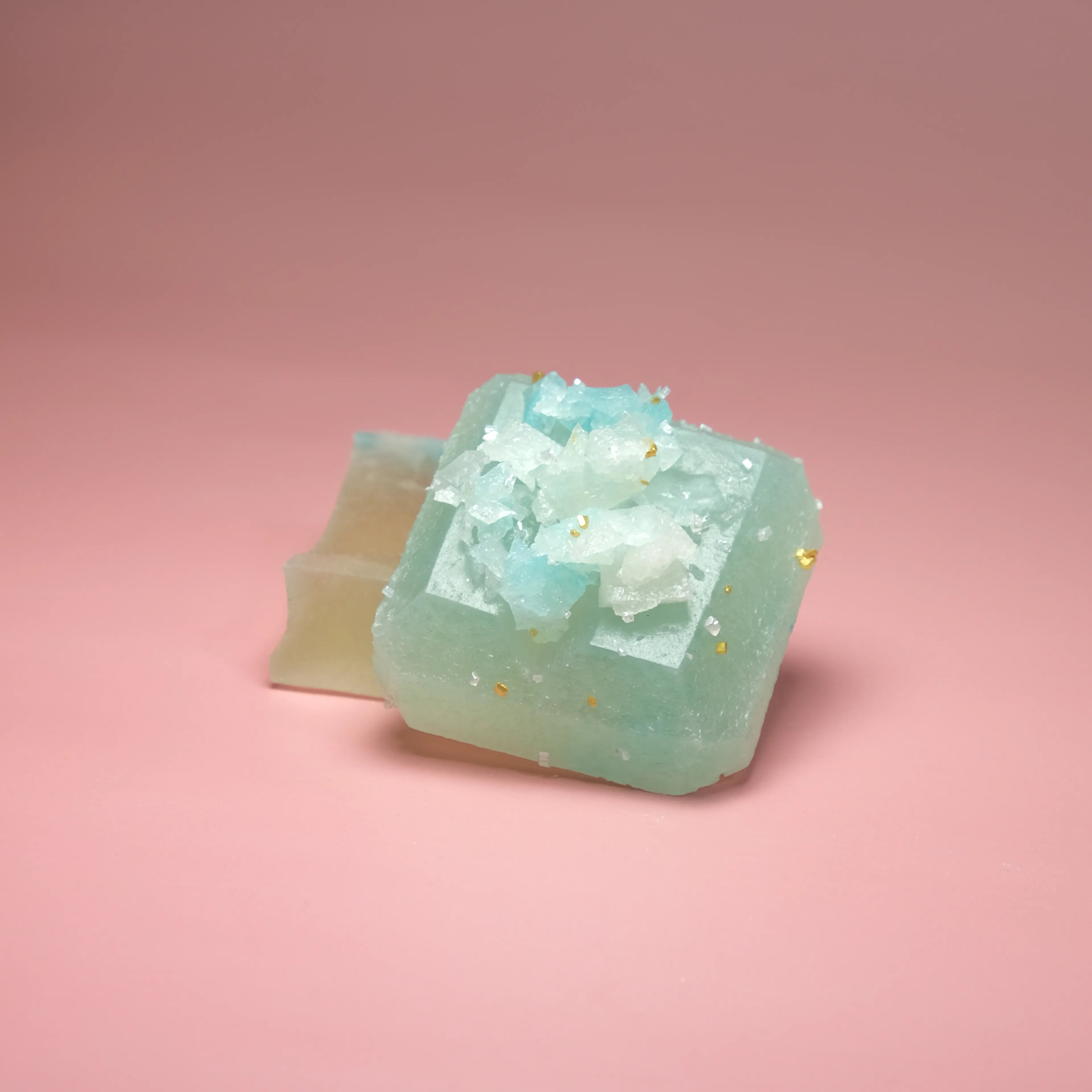 Key lime flavored Silky Gem crystal candy with a pale green translucent cube and sparkling sugar crystal center.