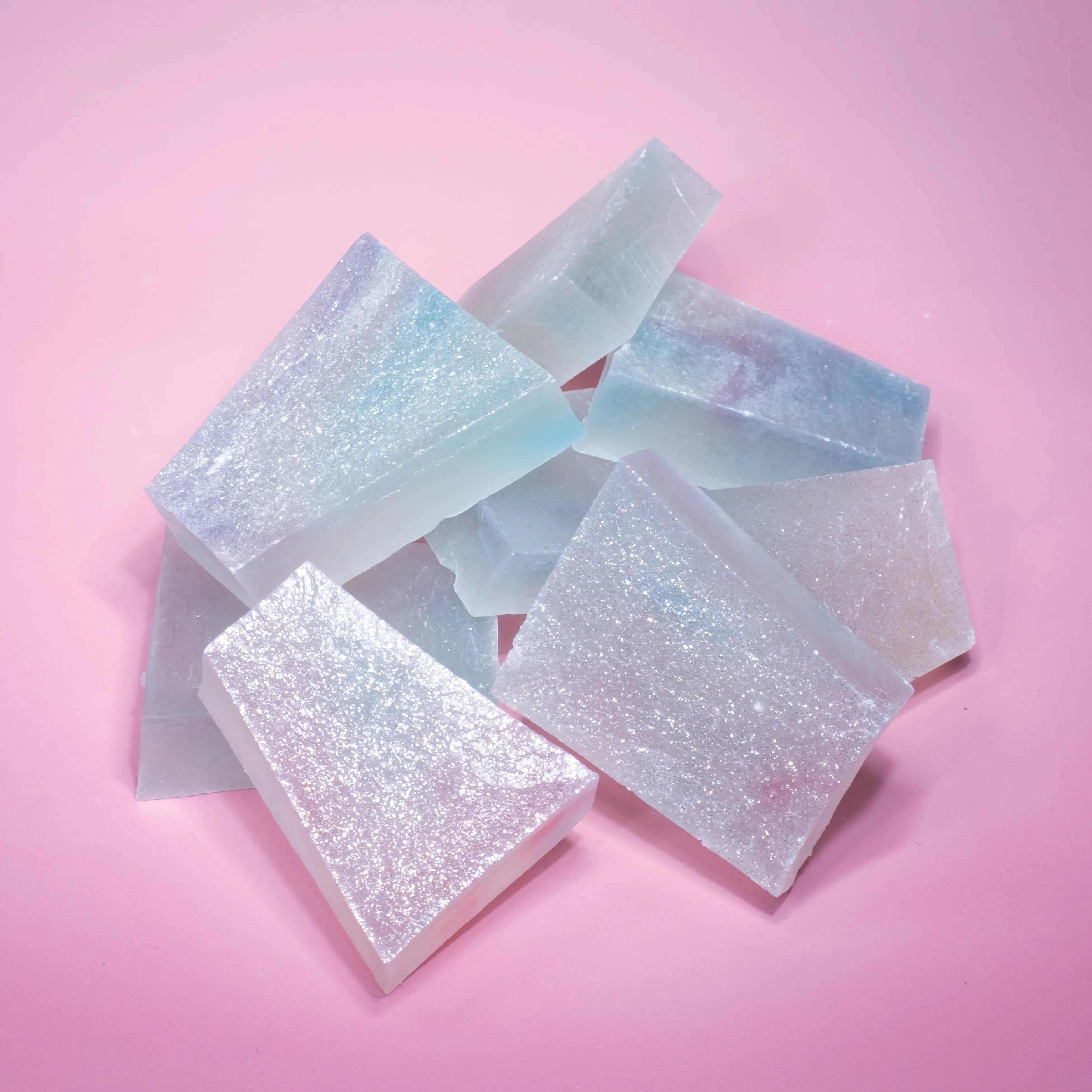 A pile of lychee aurora crystal candy with blue and purple hue, almost translucent.