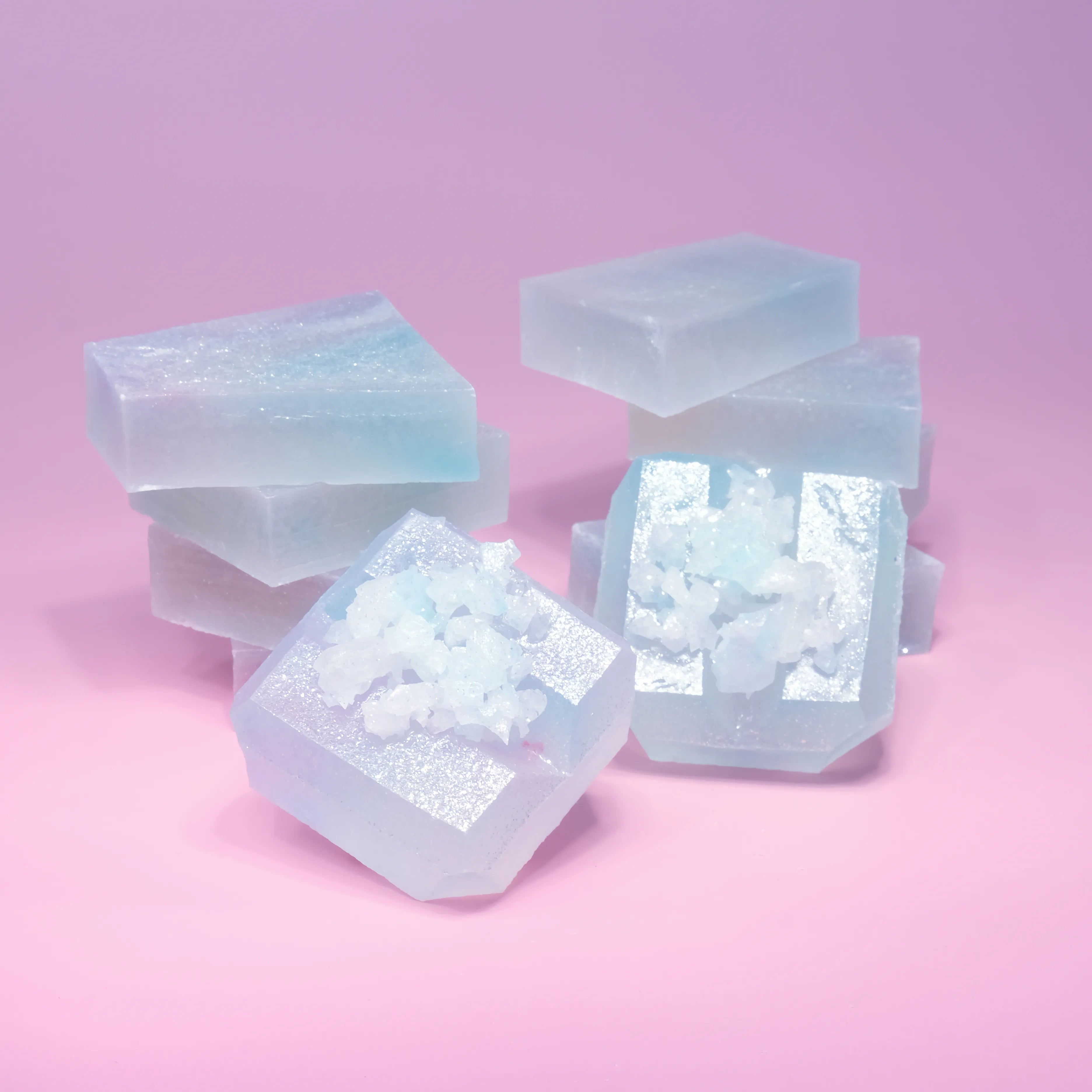 Two stacks of Silky Gem Lychee aurora candy with blue and purple hue, almost translucent.