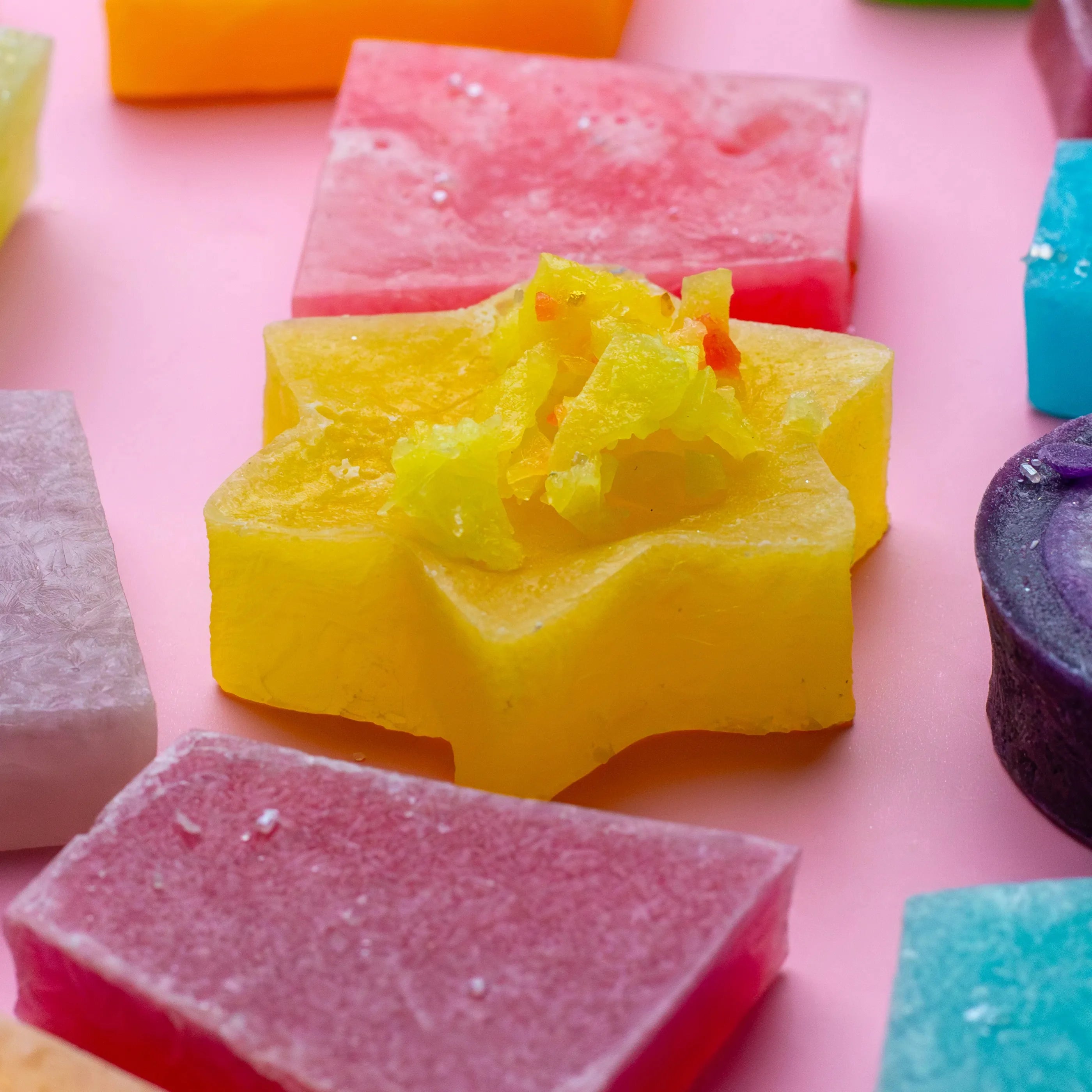 Colorful soap bars on a pink background