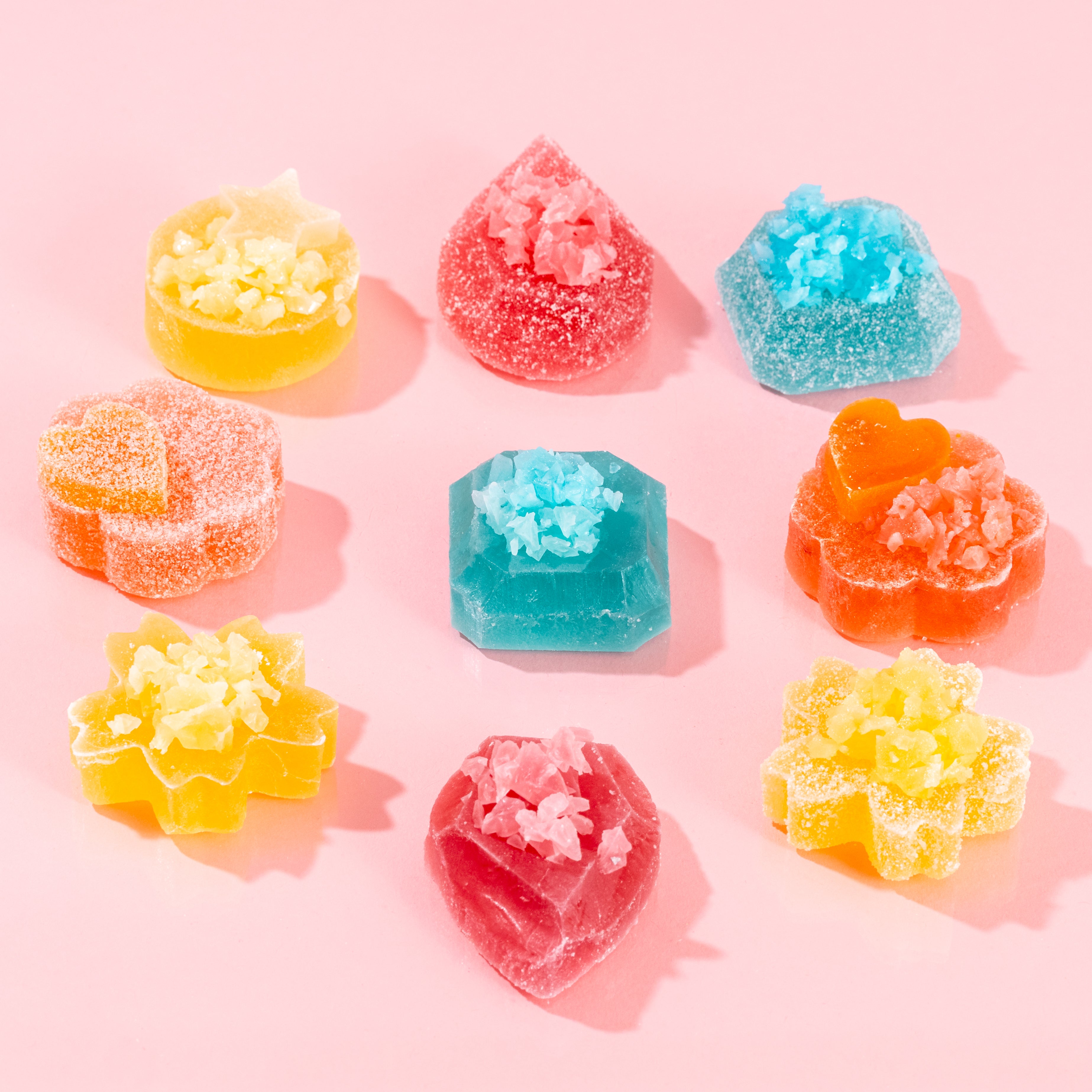 Colorful gummy candies on a pink background
