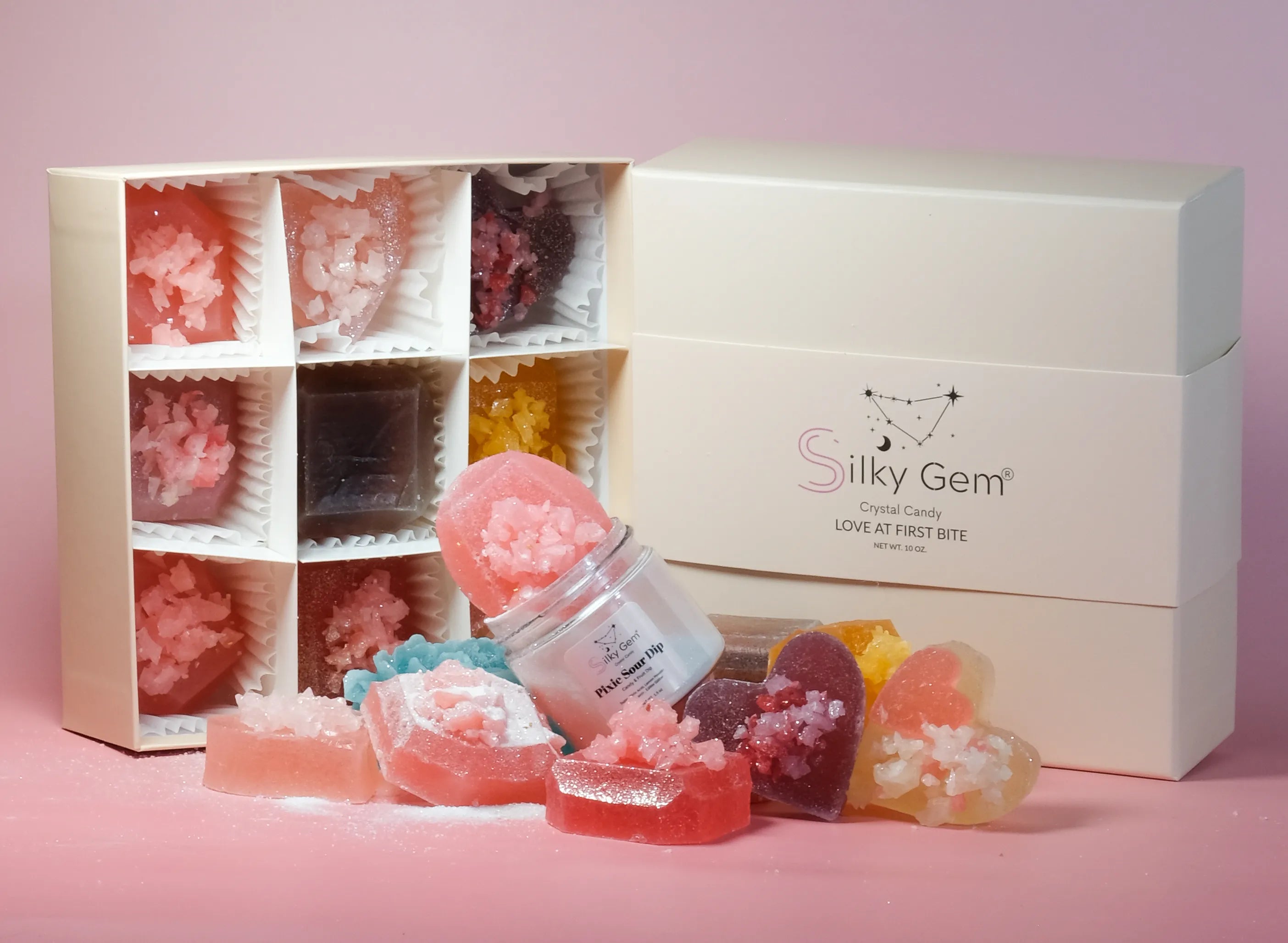 Silky Gem crystal products with packaging on a pink background