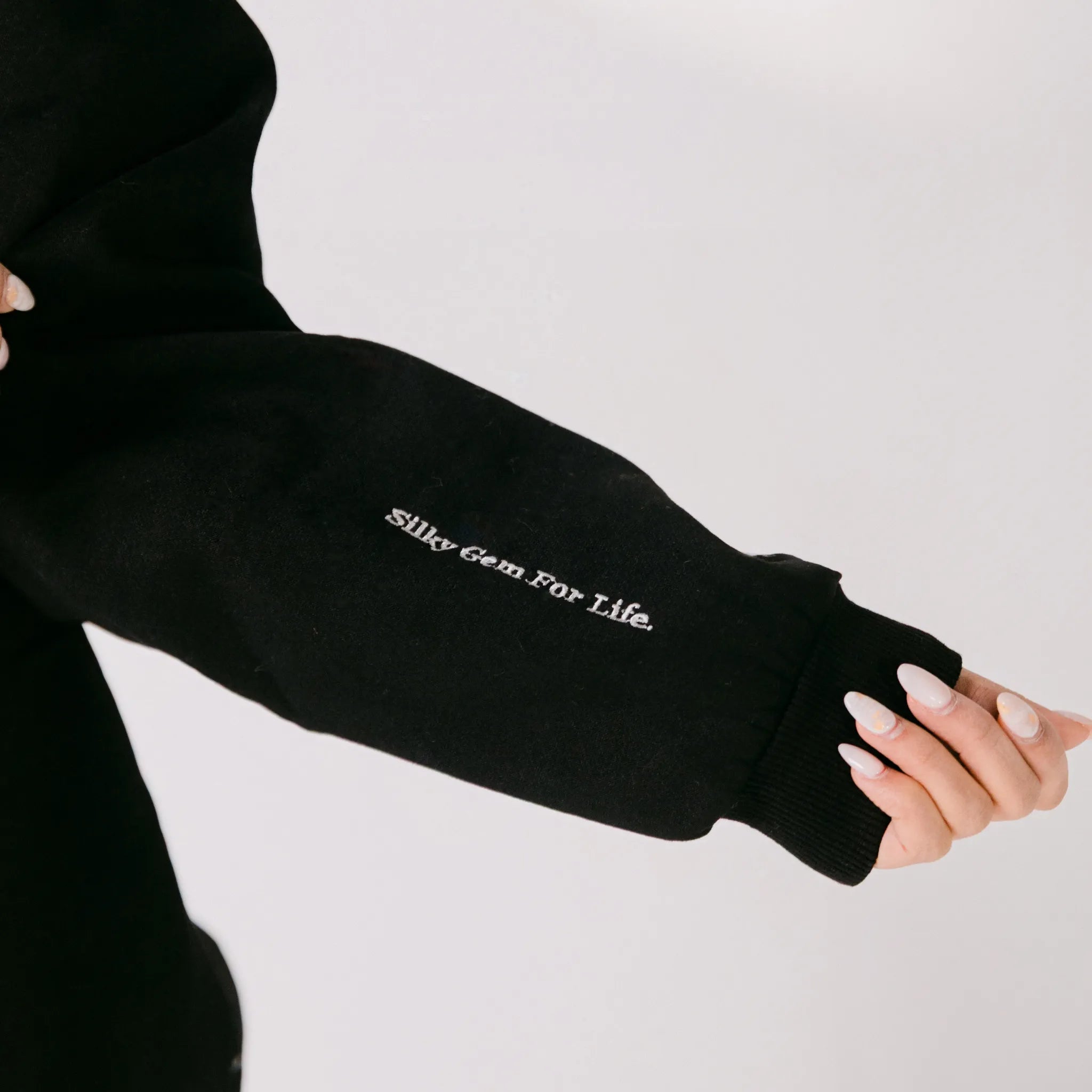 Black sleeve with 'Silky Gem For Life' text on a plain background