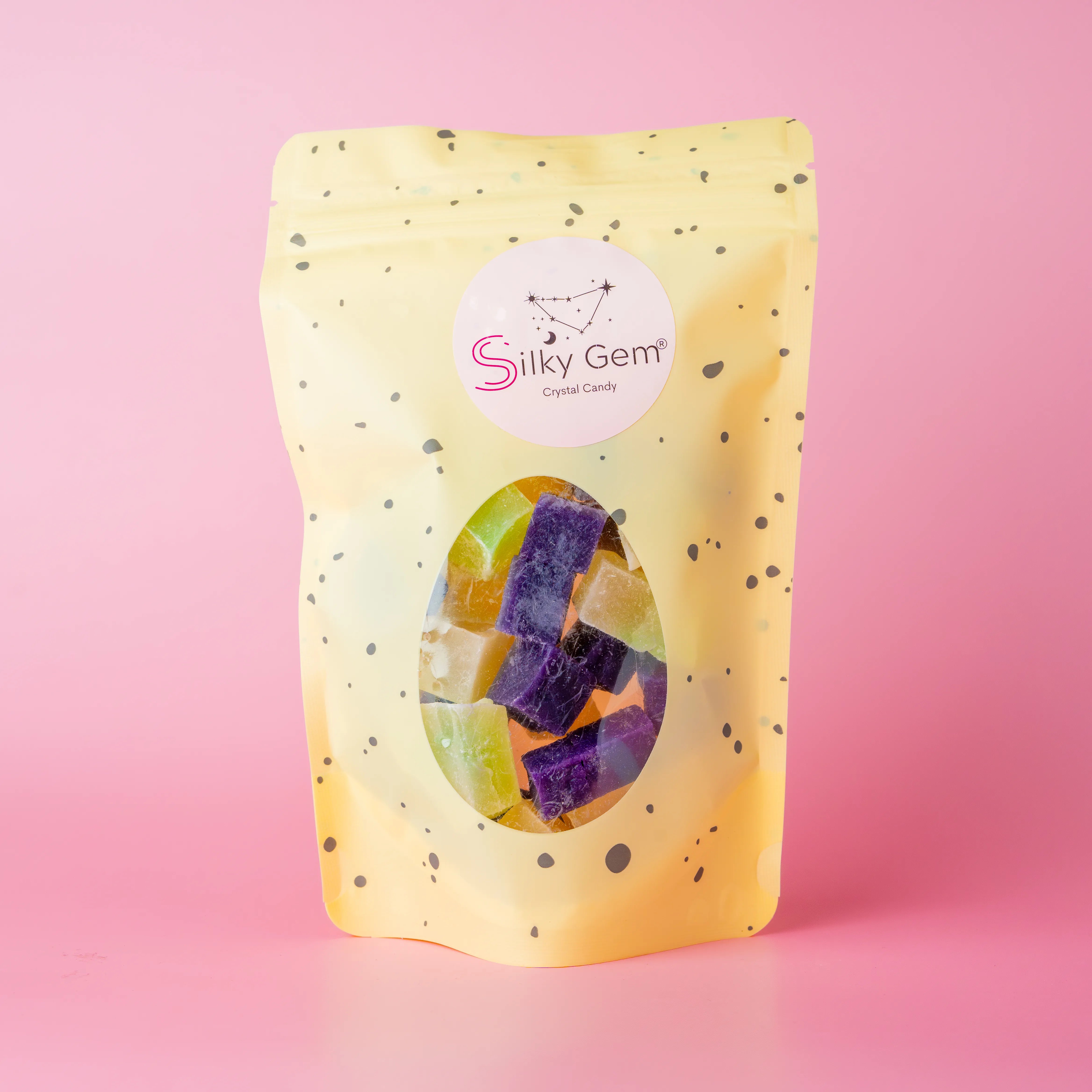 Coconut snack bites pouch with purple, white, and green crystal candy.