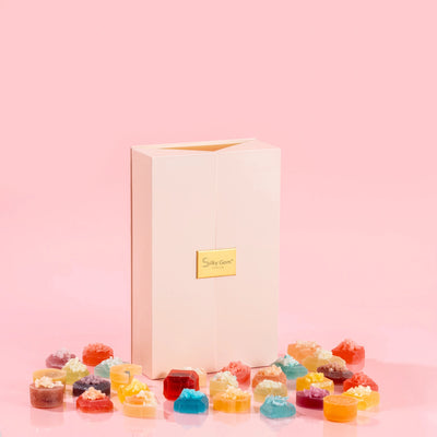 Silky Gem Gems Me Up 30-piece luxury crystal candy assortment in a premium pink/gold box on a pink background.