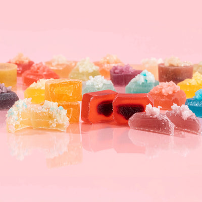 Close-up of a cut-open Silky Gem crystal candy revealing a decadent jam-filled center, from the Gems Me Up Collection.