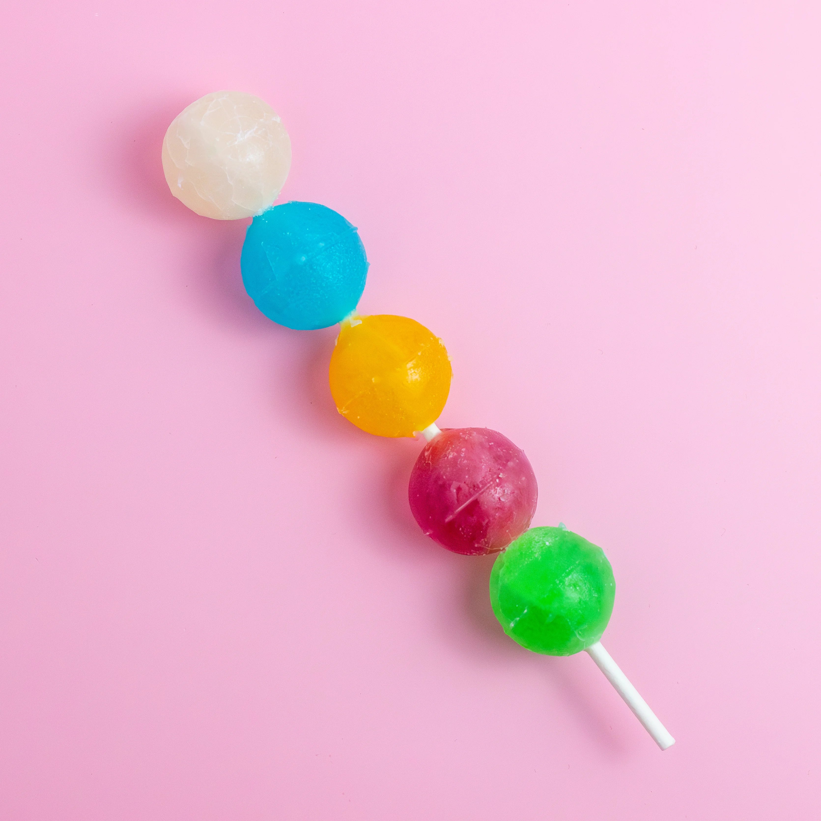 Colorful lollipops on a pink background
