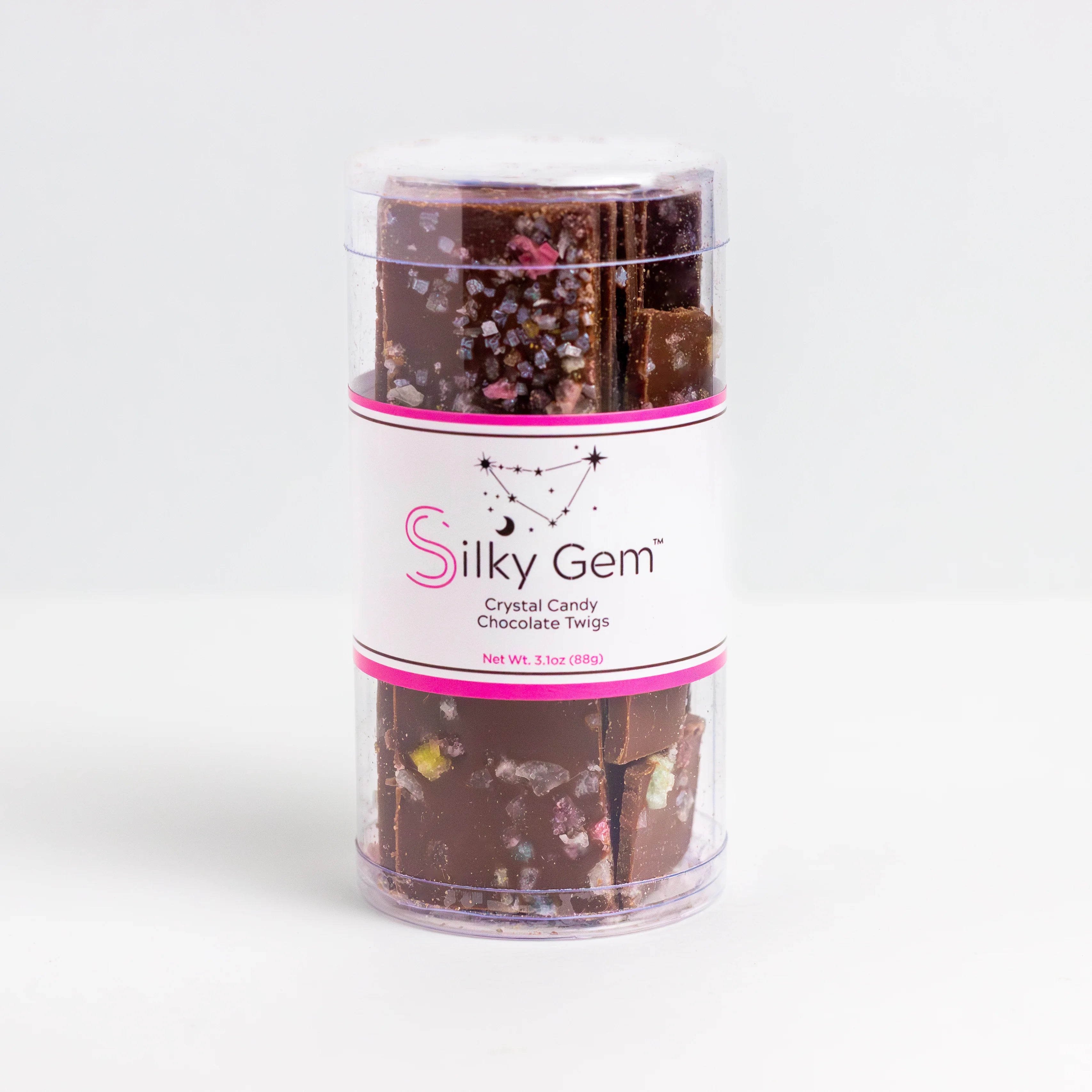 Silky Gem chocolate candy in a clear cylindrical container on a white background