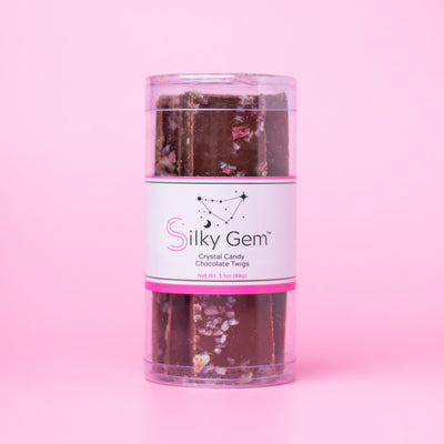 Silky Gem chocolate twigs packaging on a pink background