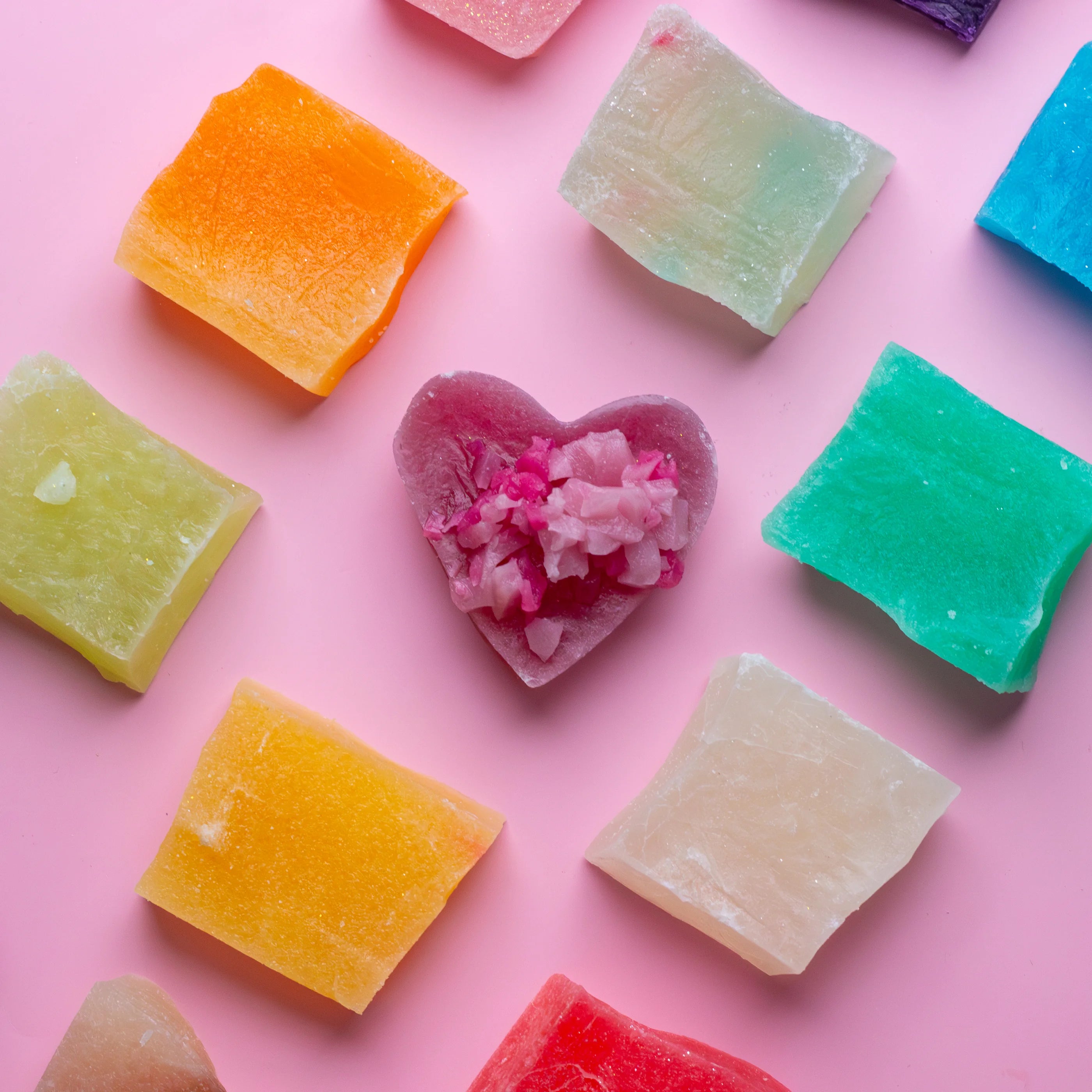 Colorful gummy candies on a pink background