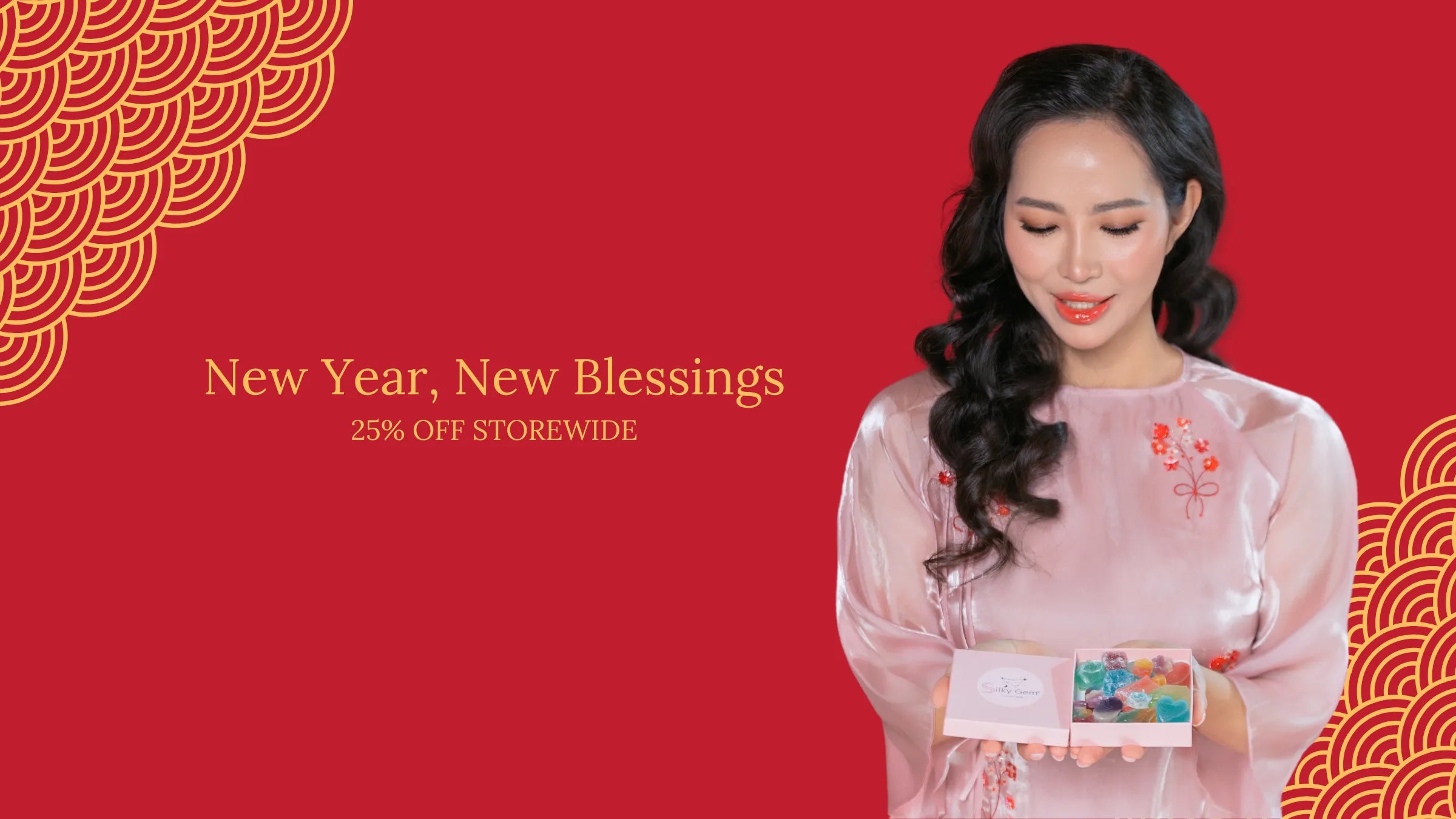 Founder of Silky Gem holding a box of crystal candy in a red Lunar New Year banner with New Year, New Blessings text