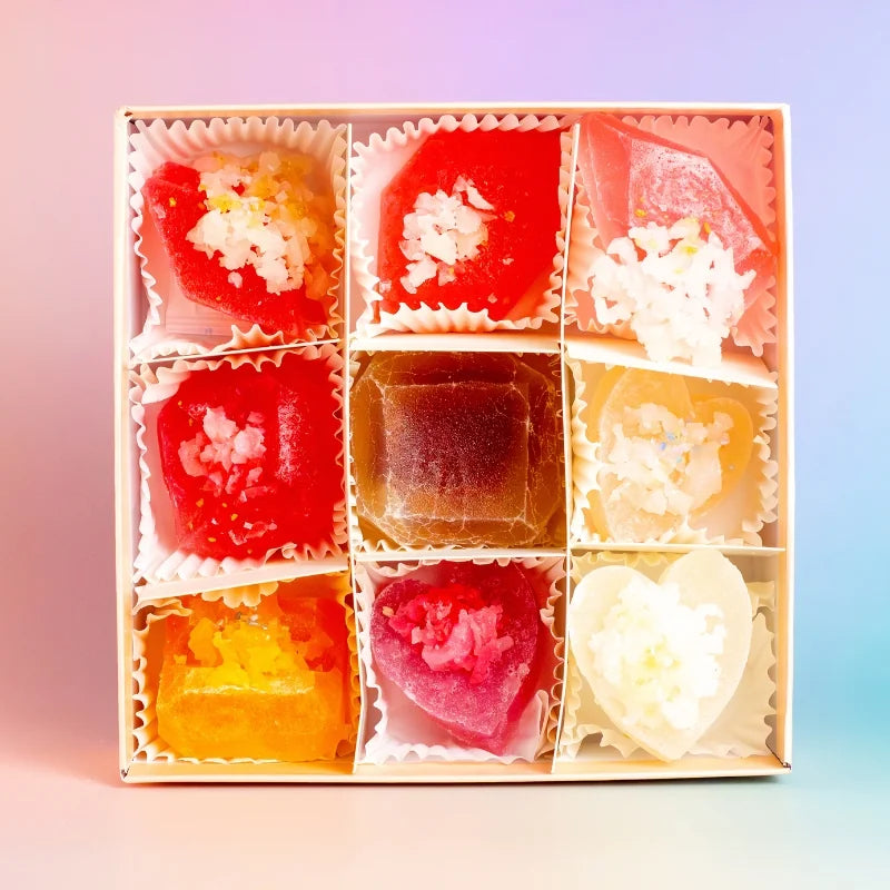 Assorted colorful jelly candies in a box with a gradient background