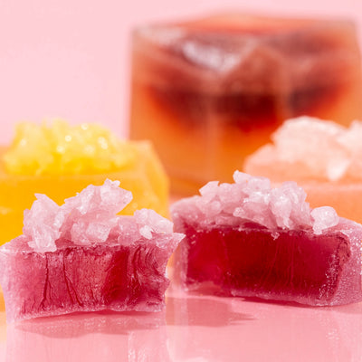 Close-up of pink and yellow Silky Gem crystal candy from the Love at First Bite collection.