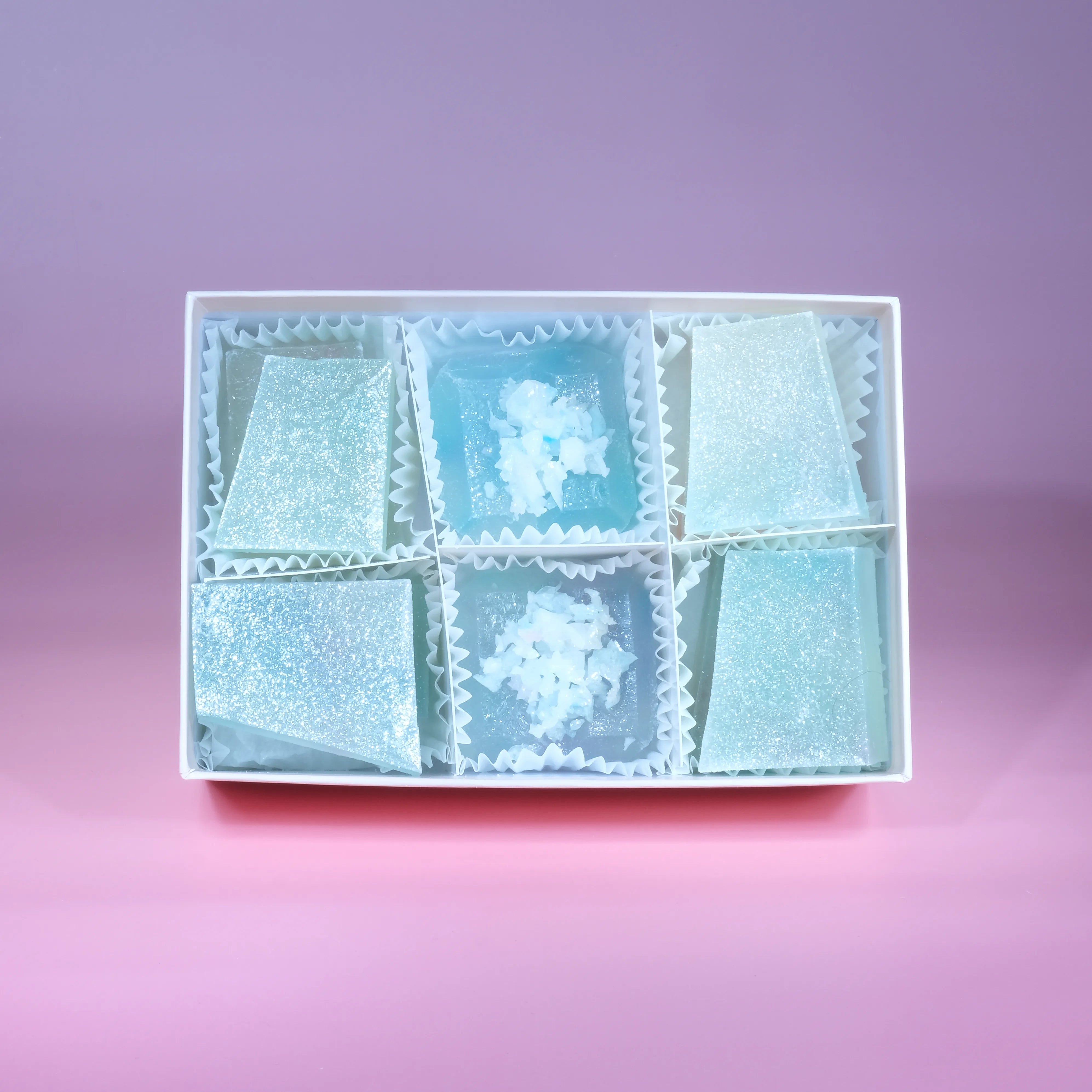 A box of lychee aurora crystal candy with blue and purple  hue, almost translucent.