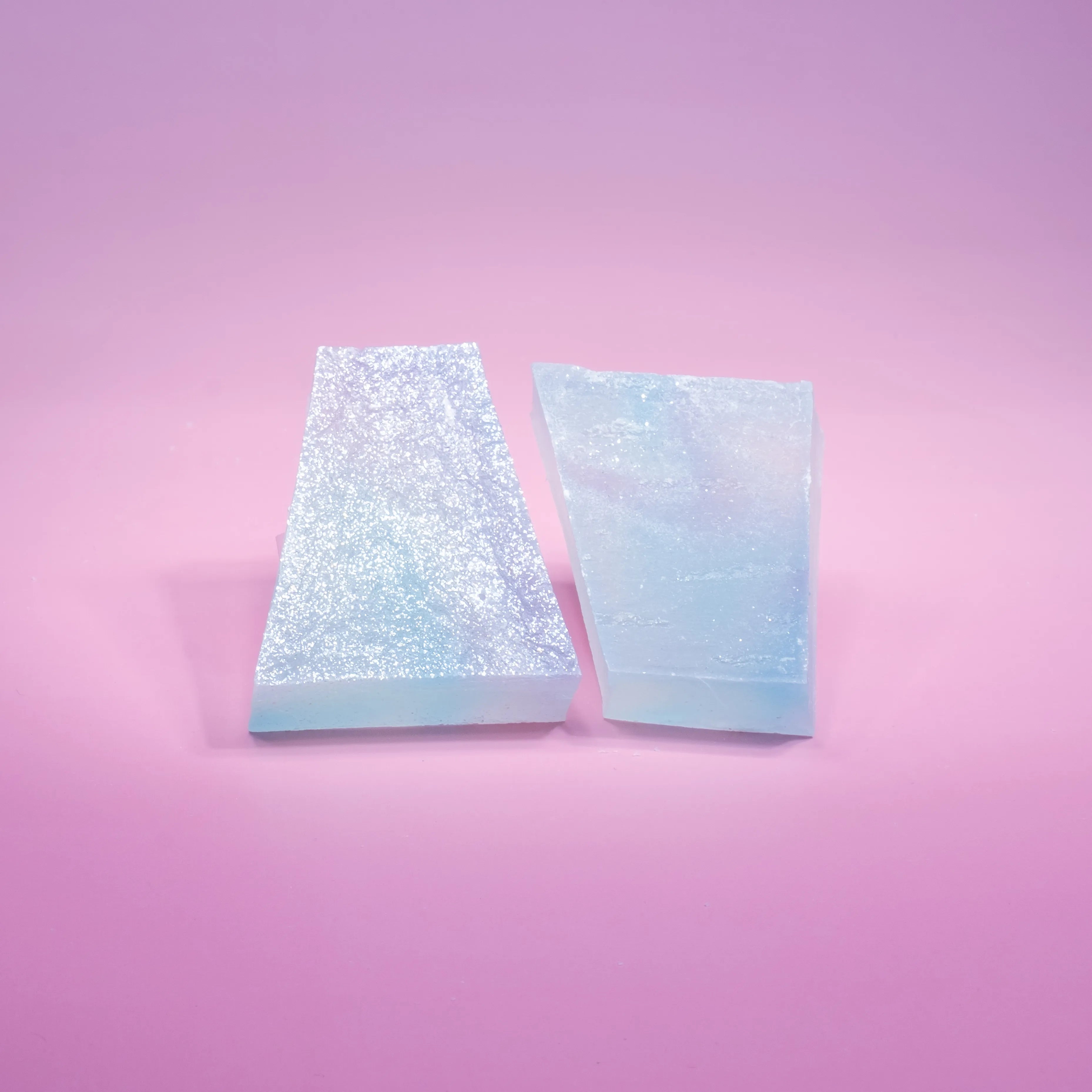 Two lychee aurora crystal candy with blue and purple  hue, almost translucent.