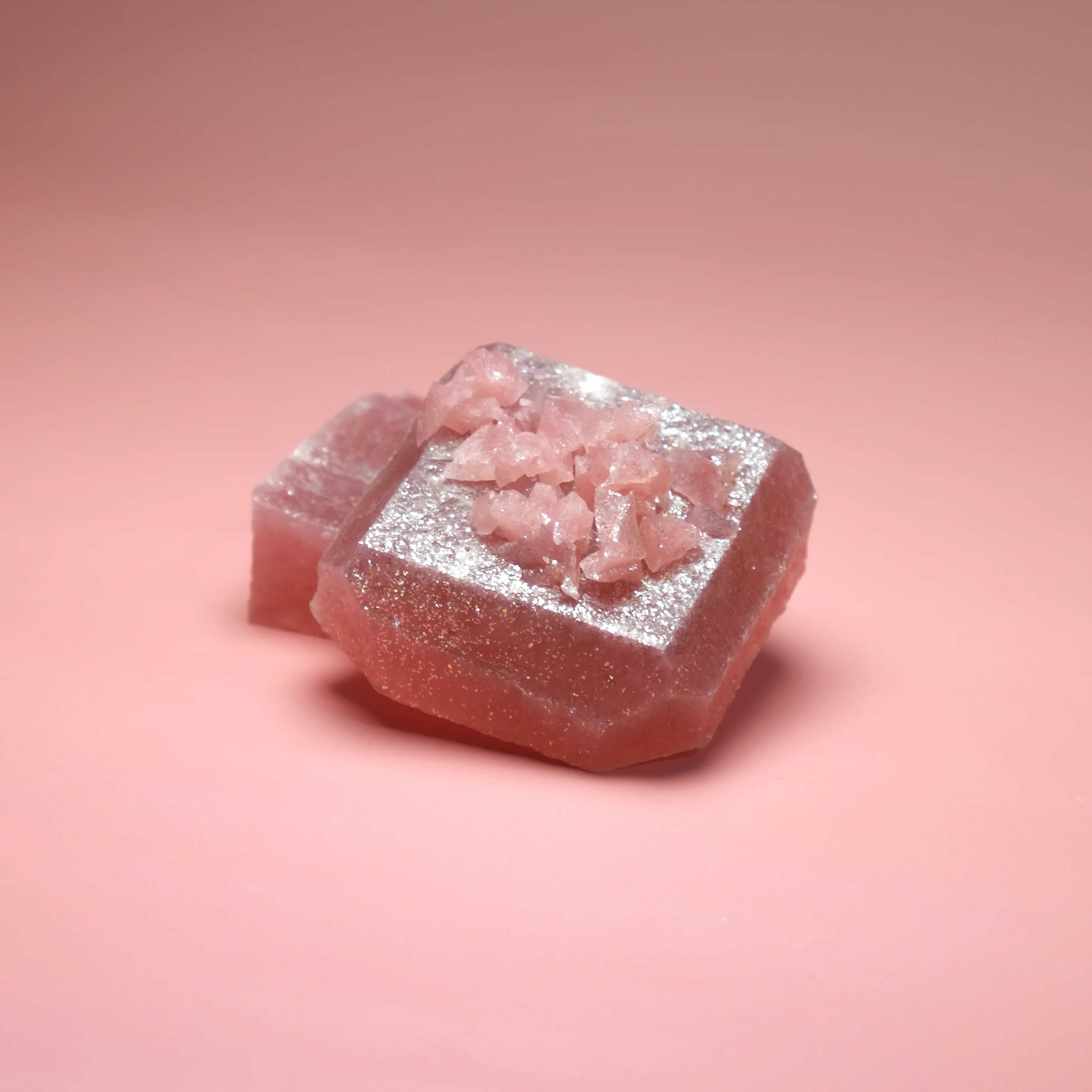 Mixed berry flavored Silky Gem crystal candy with a soft pink translucent cube and sparkling sugar crystal center.