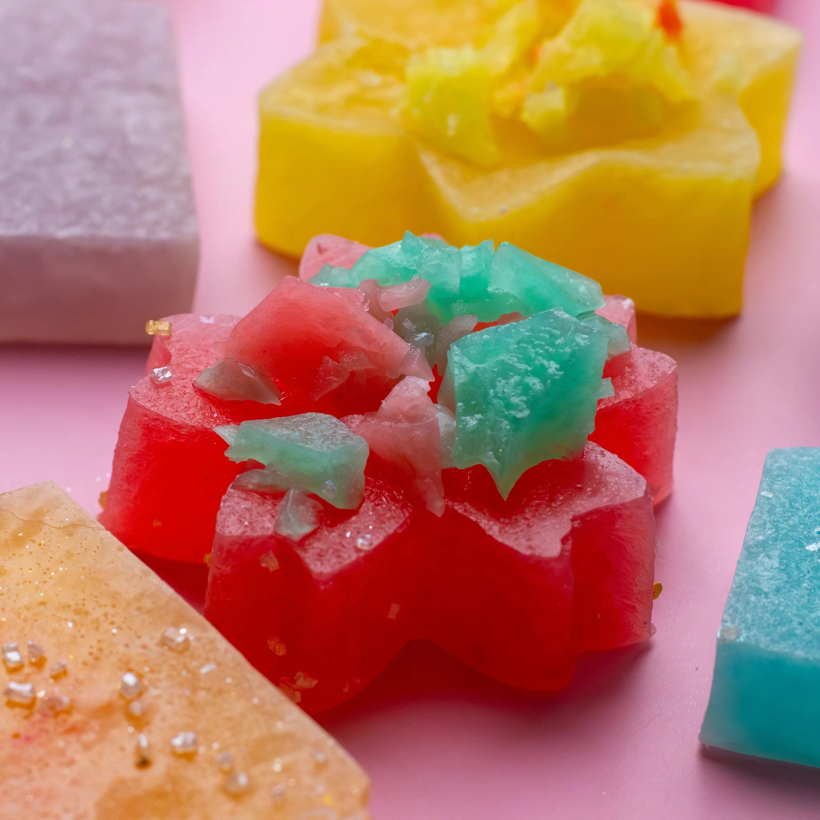 Colorful gummy candies on a pink background