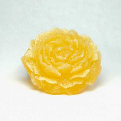 Yellow rose-shaped candy on a white background