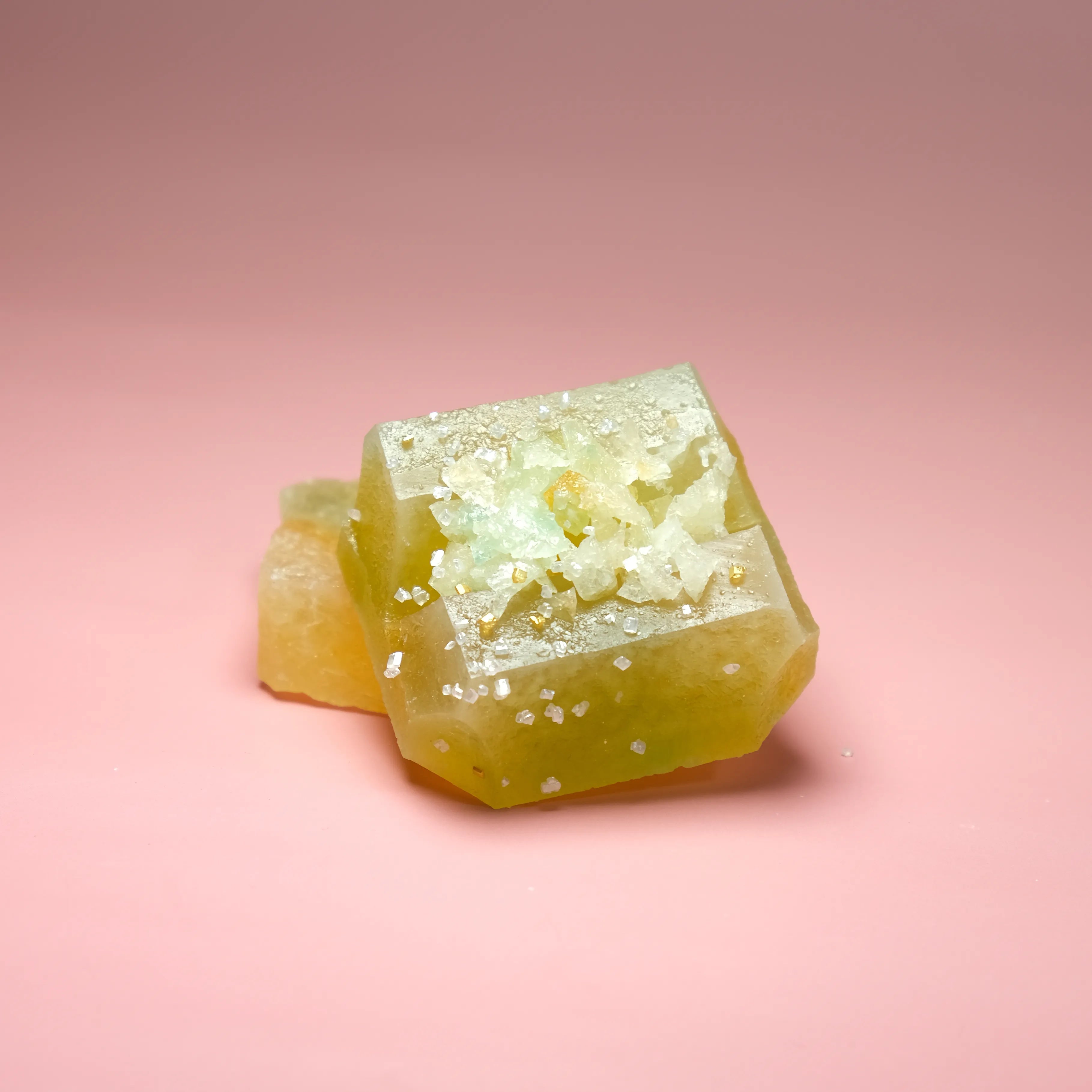 Pineapple flavored Silky Gem crystal candy with a bright yellow translucent cube and sparkling crystal sugar garnish.