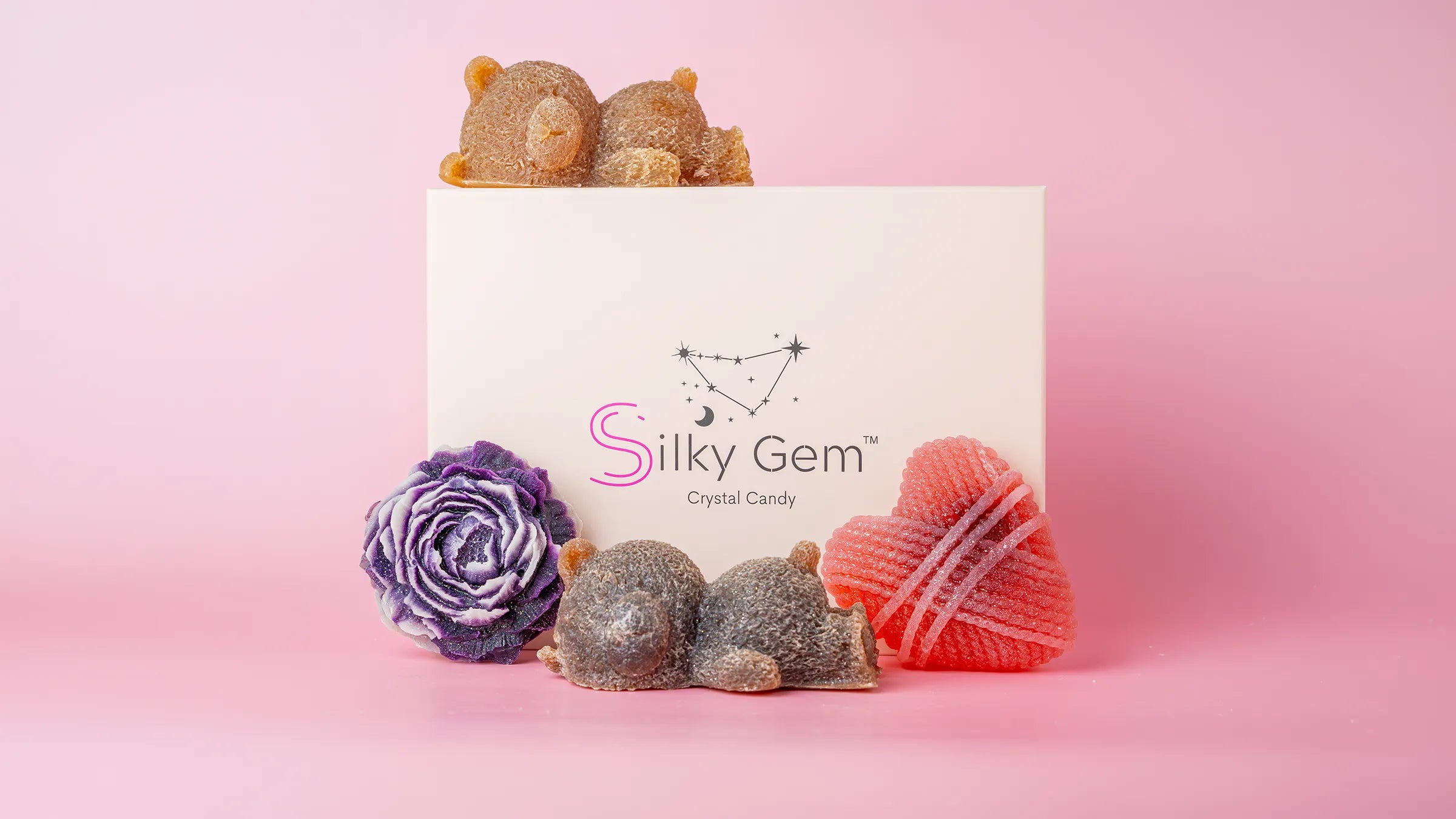 Silky Gem box with a collection of crystal candies. Purple peony, sleeping bears, and heart.