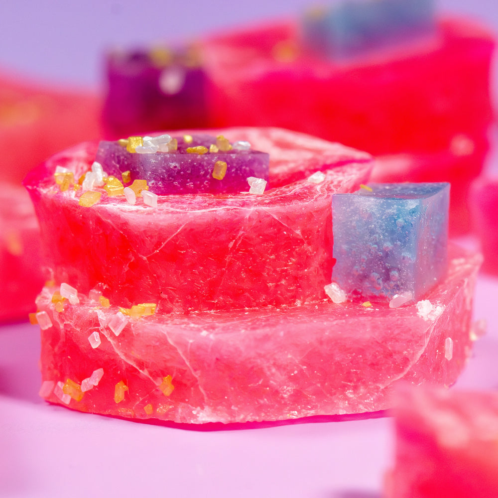 Colorful Watermelon Citrus Pink Calcite crystal candy pieces on a pink background