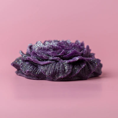 Peony Dream glittery flower-shaped crystal candy on a pink background