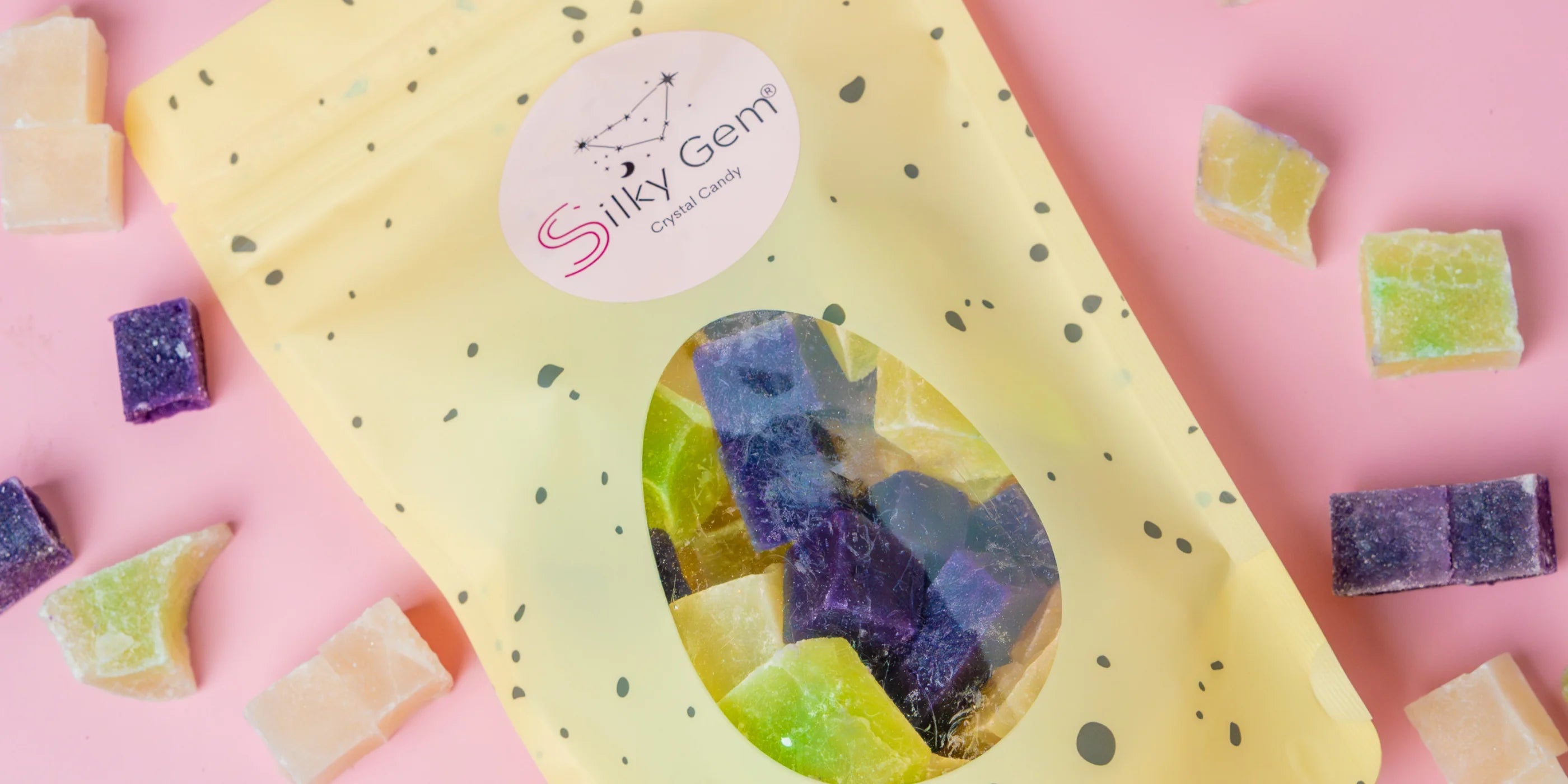 Silky Gem candy packaging with colorful candy pieces on a pink background