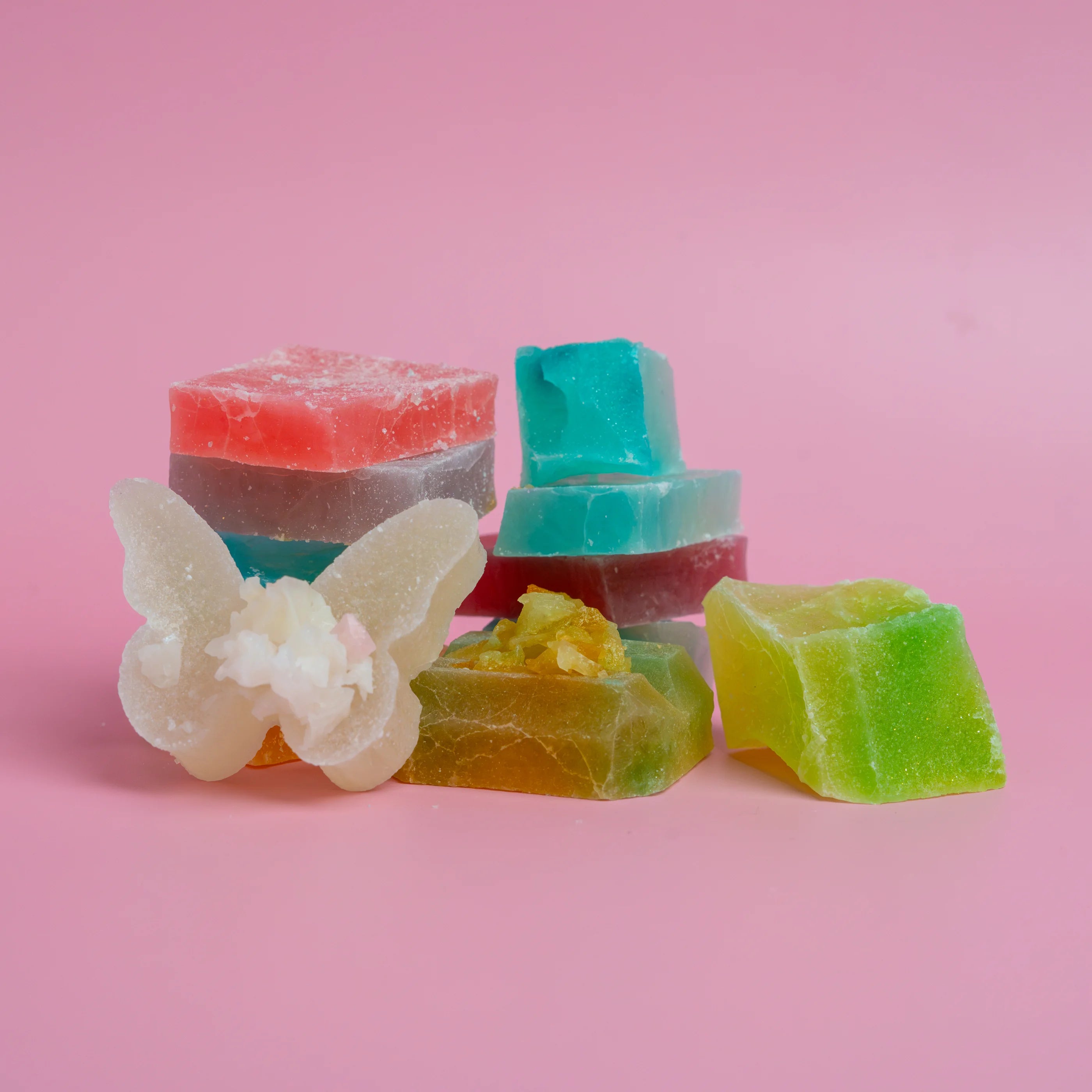 Colorful gummy candies on a pink background