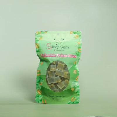 Green package of Silky Gem Pistachio Prism Bites on a light green background