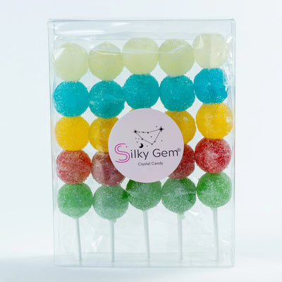 Silky Gem Sizzle Pops sour crystal candy skewers on a bright background