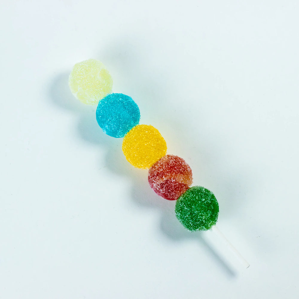 Sizzle Pop crystal candies with sparkling sour coating on a skewer