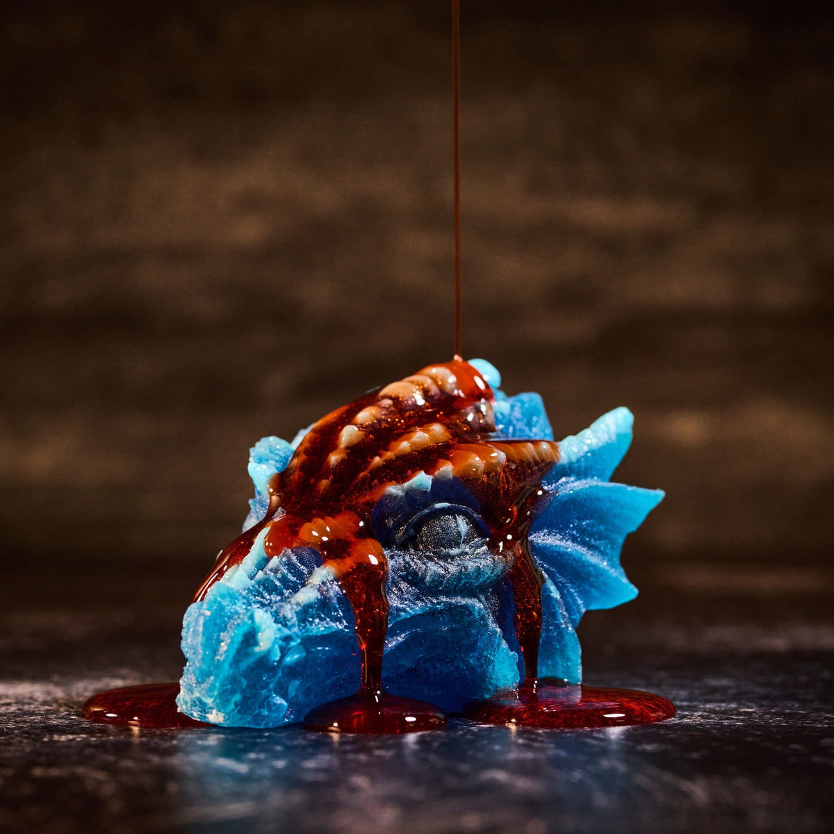 Sour Blood Orange Gel shown drizzled over blue Wicked Wonders dragon crystal candy