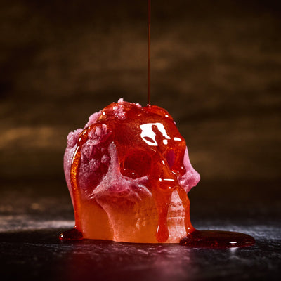 Sour Mango & Passion Fruit Gel shown drizzled over pink Wicked Wonders skull crystal candy